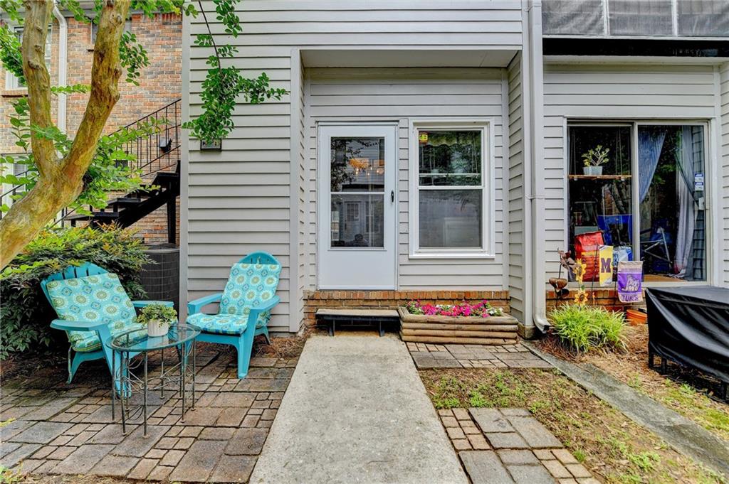 6700 Roswell Road, Unit 22B Atlanta, GA 30328 - Photo 30 of 34 a front view of a house with outdoor seating