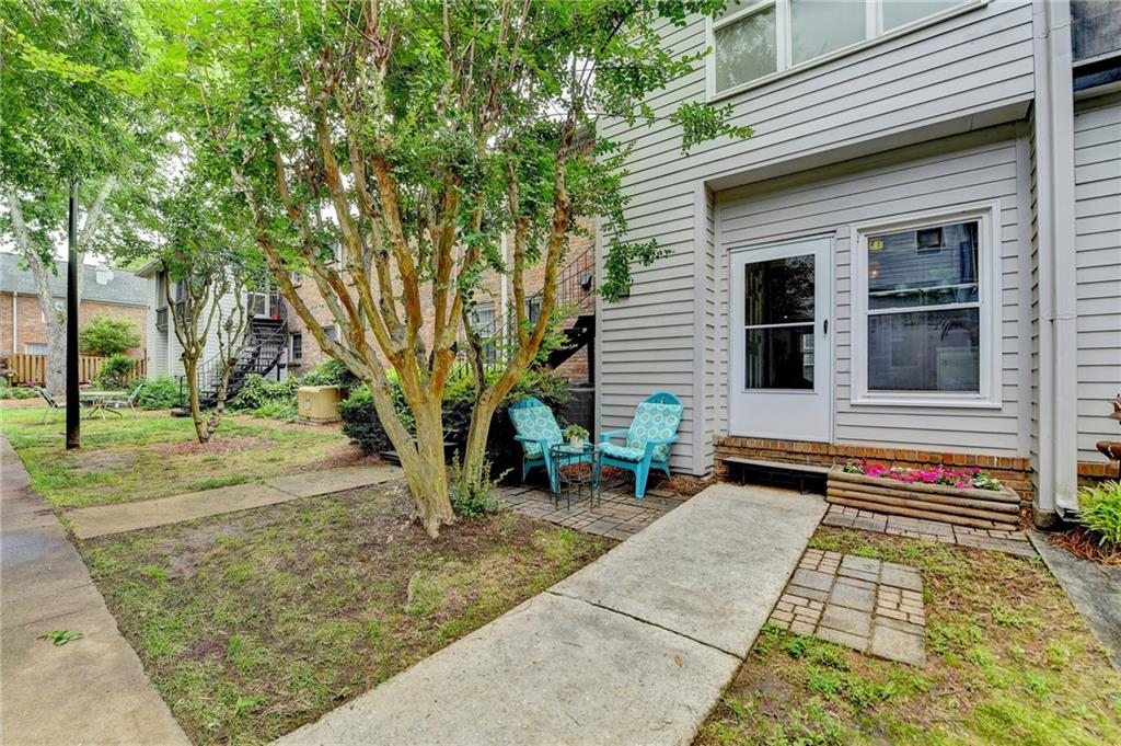 6700 Roswell Road, Unit 22B Atlanta, GA 30328 - Photo 31 of 34 a backyard of a house with barbeque oven table and chairs