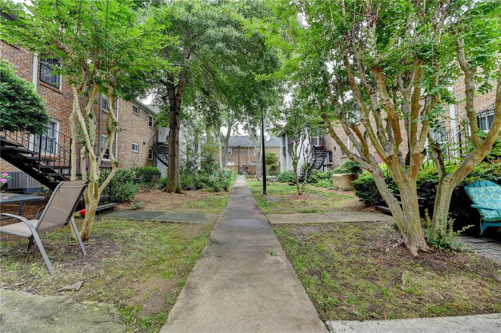 6700 Roswell Road, Unit 22B Atlanta, GA 30328 - Photo 32 of 34 a view of a pathway with a house in the background