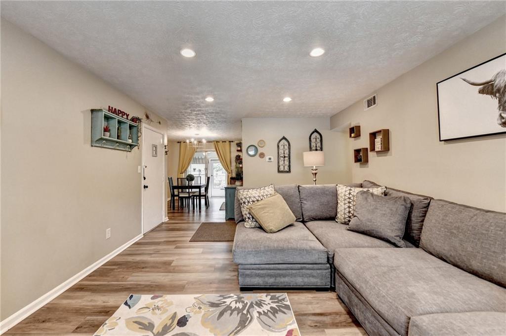 6700 Roswell Road, Unit 22B Atlanta, GA 30328 - Photo 4 of 34 a living room with furniture and kitchen view