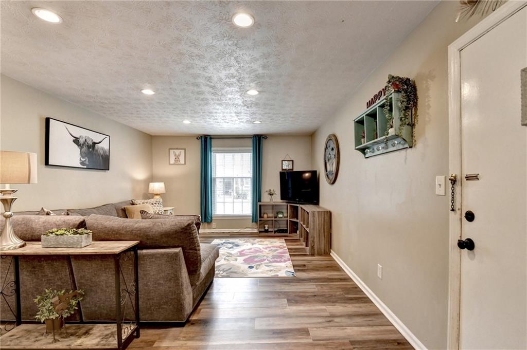 6700 Roswell Road, Unit 22B Atlanta, GA 30328 - Photo 5 of 34 a living room with furniture and a rug