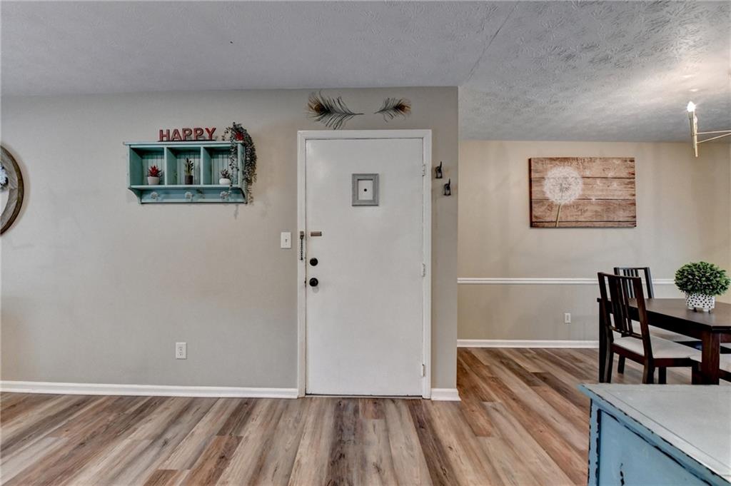 6700 Roswell Road, Unit 22B Atlanta, GA 30328 - Photo 6 of 34 a view of dining room with wooden floor and furniture