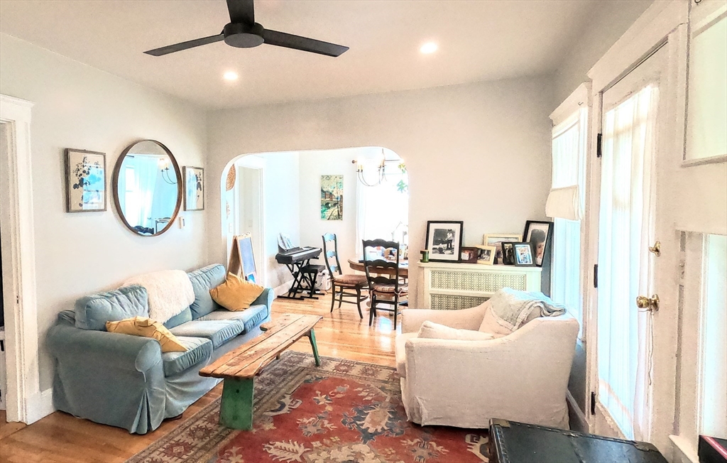 12 Searle Road, Unit 12 Boston, MA 02132 - Photo 13 of 35 a living room with furniture a mirror and a large window