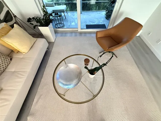 a view of a livingroom with furniture and hardwood floor