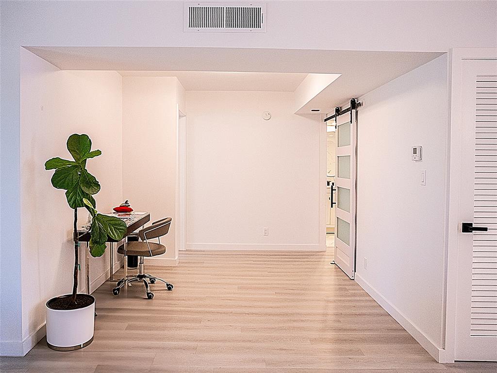 10 Southeast 13th Street, Unit B3 Boca Raton, FL 33432 - Photo 17 of 85 a view of a hallway with wooden floor and a potted plant