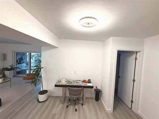 a bedroom with a large bed and a flat tv screen on dresser