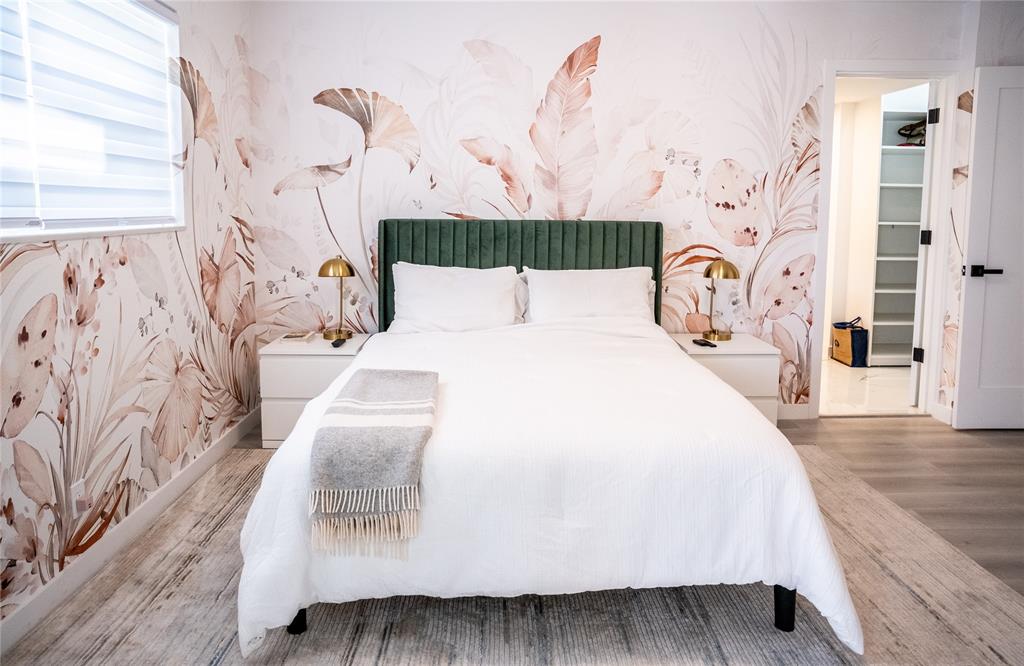 10 Southeast 13th Street, Unit B3 Boca Raton, FL 33432 - Photo 21 of 85 a bed sitting in a bedroom next to a window with a chandelier