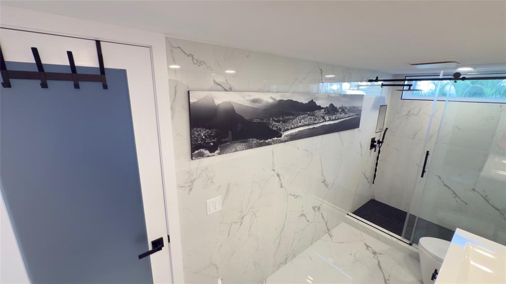 10 Southeast 13th Street, Unit B3 Boca Raton, FL 33432 - Photo 25 of 85 a bathroom with a sink and shower