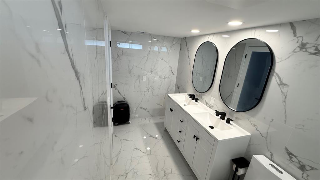 10 Southeast 13th Street, Unit B3 Boca Raton, FL 33432 - Photo 39 of 85 a bathroom with double vanity sink and mirror