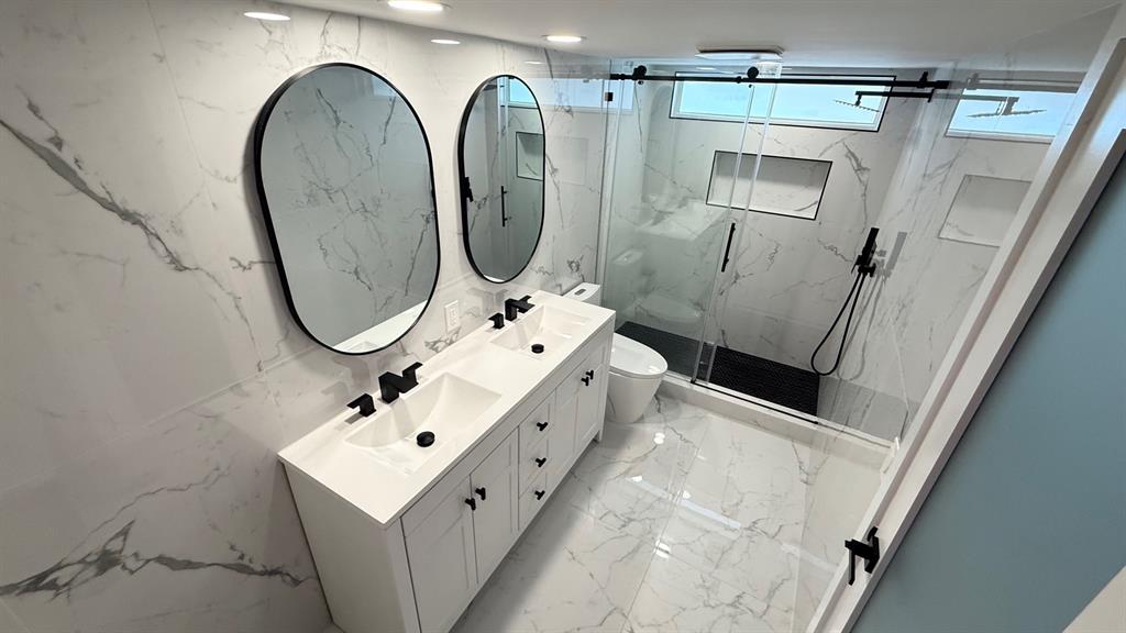 10 Southeast 13th Street, Unit B3 Boca Raton, FL 33432 - Photo 41 of 85 a bathroom with a sink vanity mirror and toilet