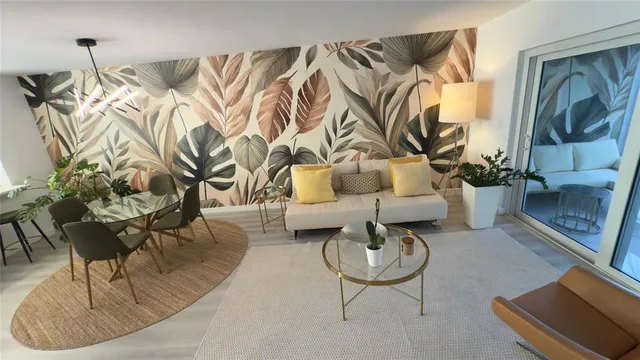 a living room with furniture and a floor to ceiling window