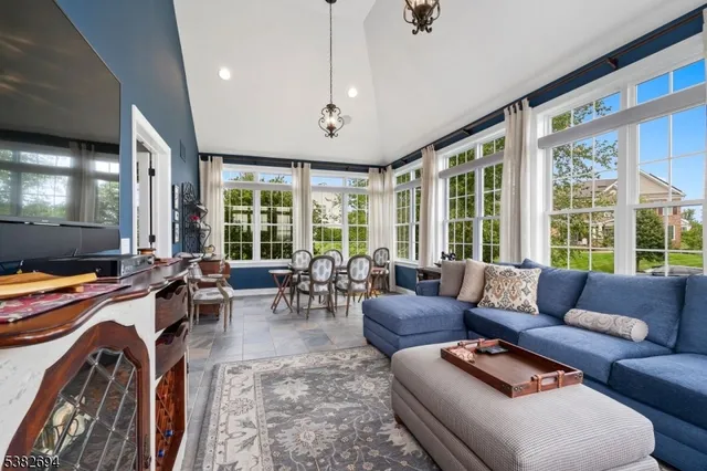 a living room with furniture and large windows
