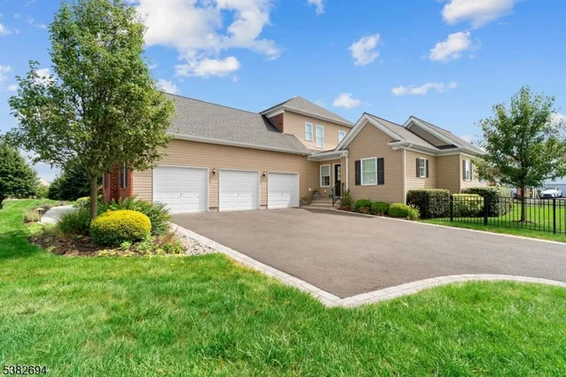 a front view of a house with a garden and plants
