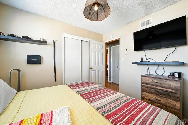 a bedroom with a bed and a flat screen tv