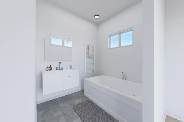 a white bath tub sitting next to a white sink