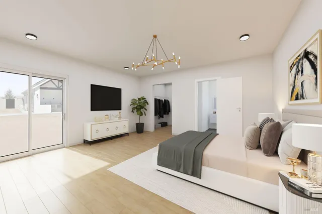 a spacious bedroom with a bed and a flat screen tv