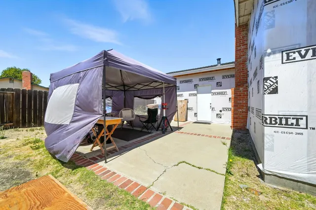 a view of a backyard with sitting area