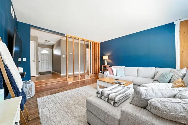 a living room with furniture and wooden floor