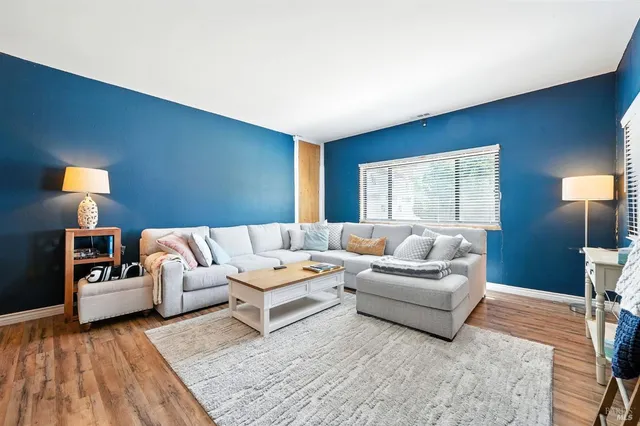 a living room with furniture and a lamp