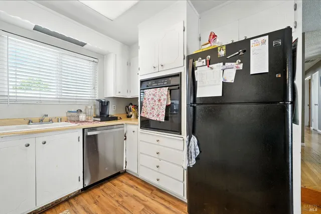 a kitchen with stainless steel appliances a refrigerator sink and cabinets