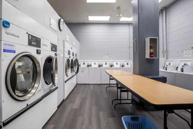 a view of a kitchen with furniture and wooden floor