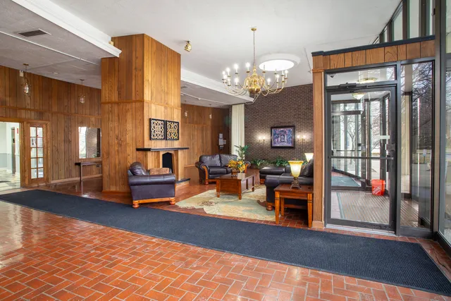 a lobby with furniture and a chandelier