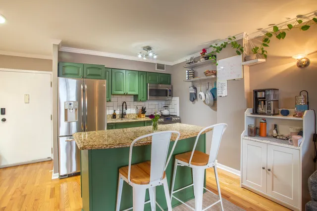 a kitchen with stainless steel appliances granite countertop a refrigerator and microwave