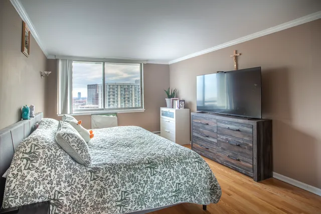 a bedroom with a bed and a flat screen tv