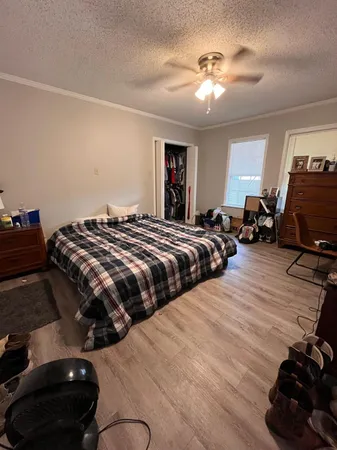 a bed room with bed and a chandelier