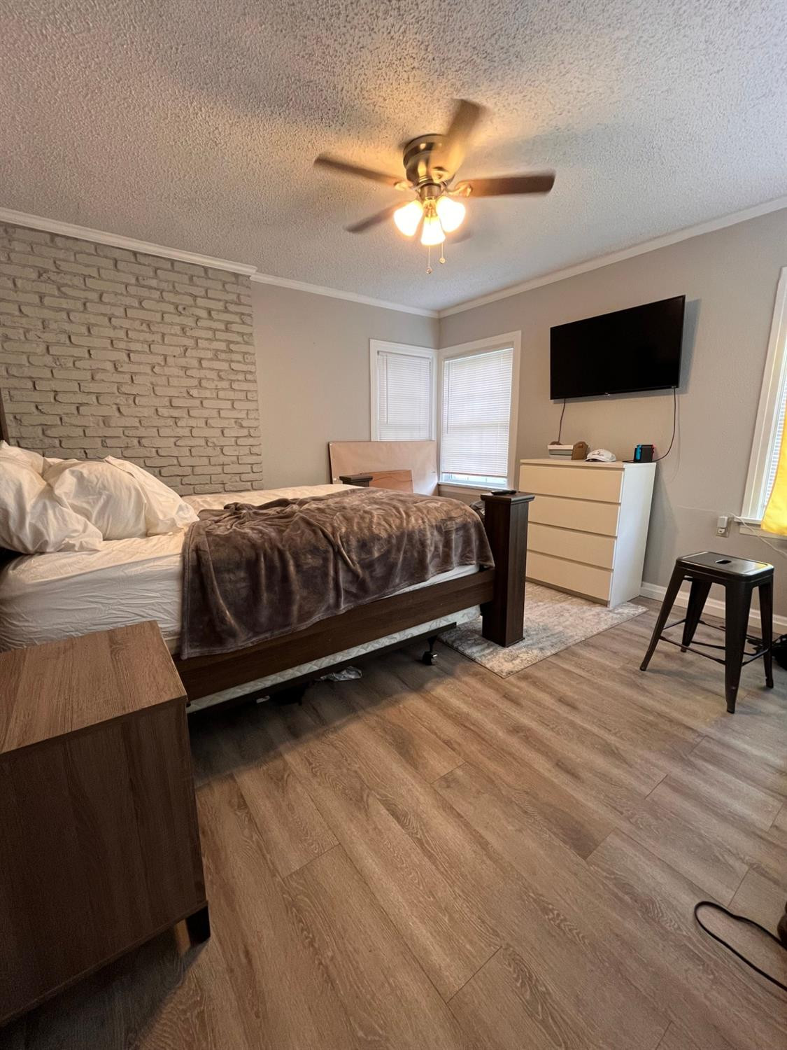 2613 25th Street, Unit FRONT Lubbock, TX 79410 - Photo 9 of 18 a bedroom with a bed and a flat screen tv