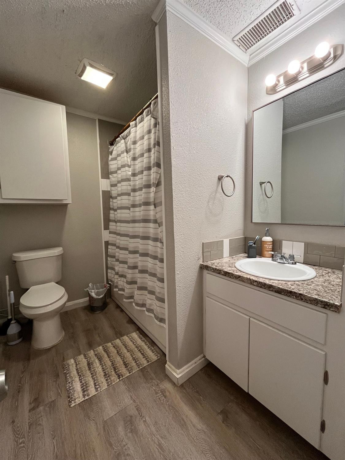 2613 25th Street, Unit FRONT Lubbock, TX 79410 - Photo 10 of 18 a bathroom with a sink a toilet and shower