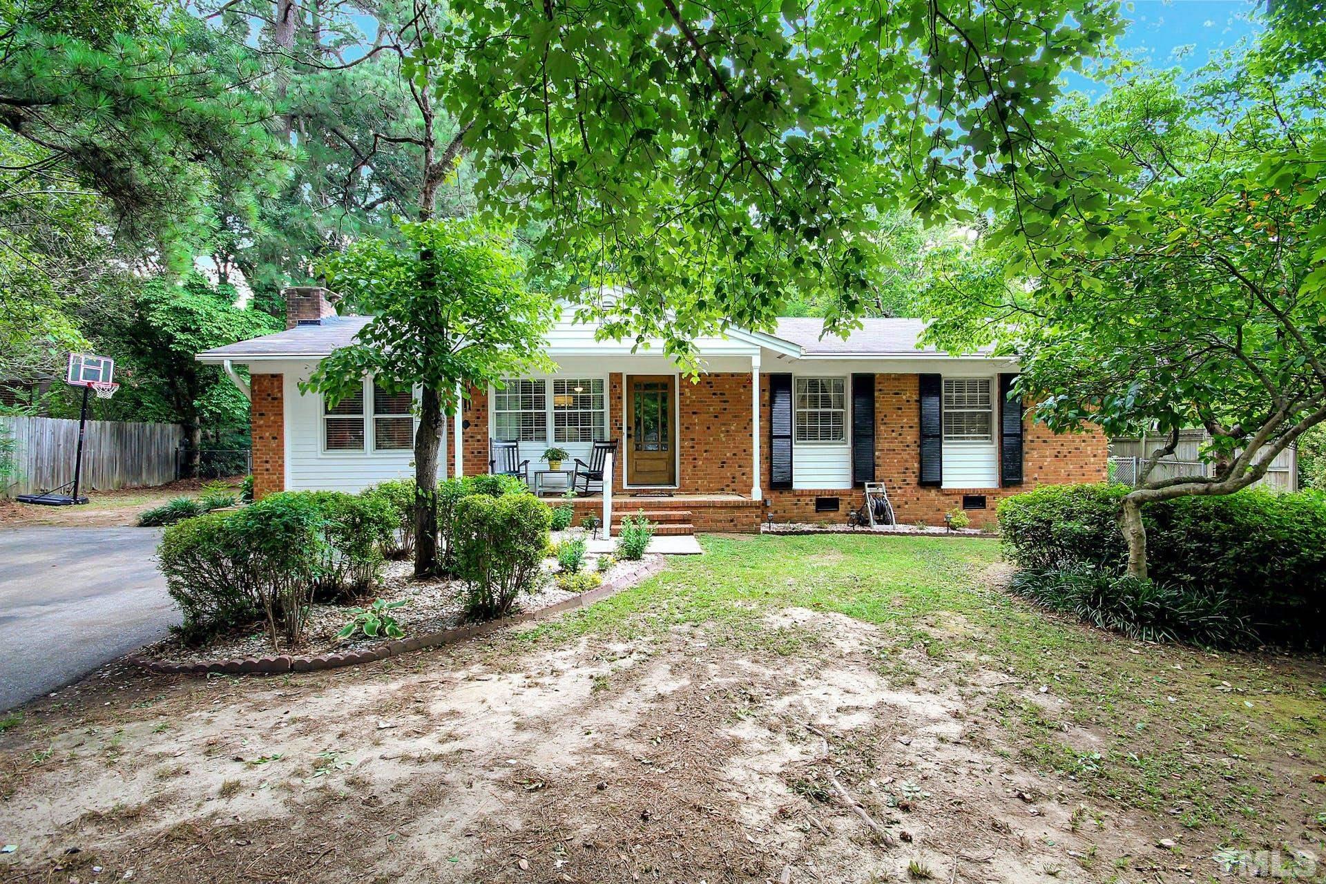 5913 Meadowbrook Road Raleigh, NC 27603 - Photo 1 of 24 a front view of a house with garden