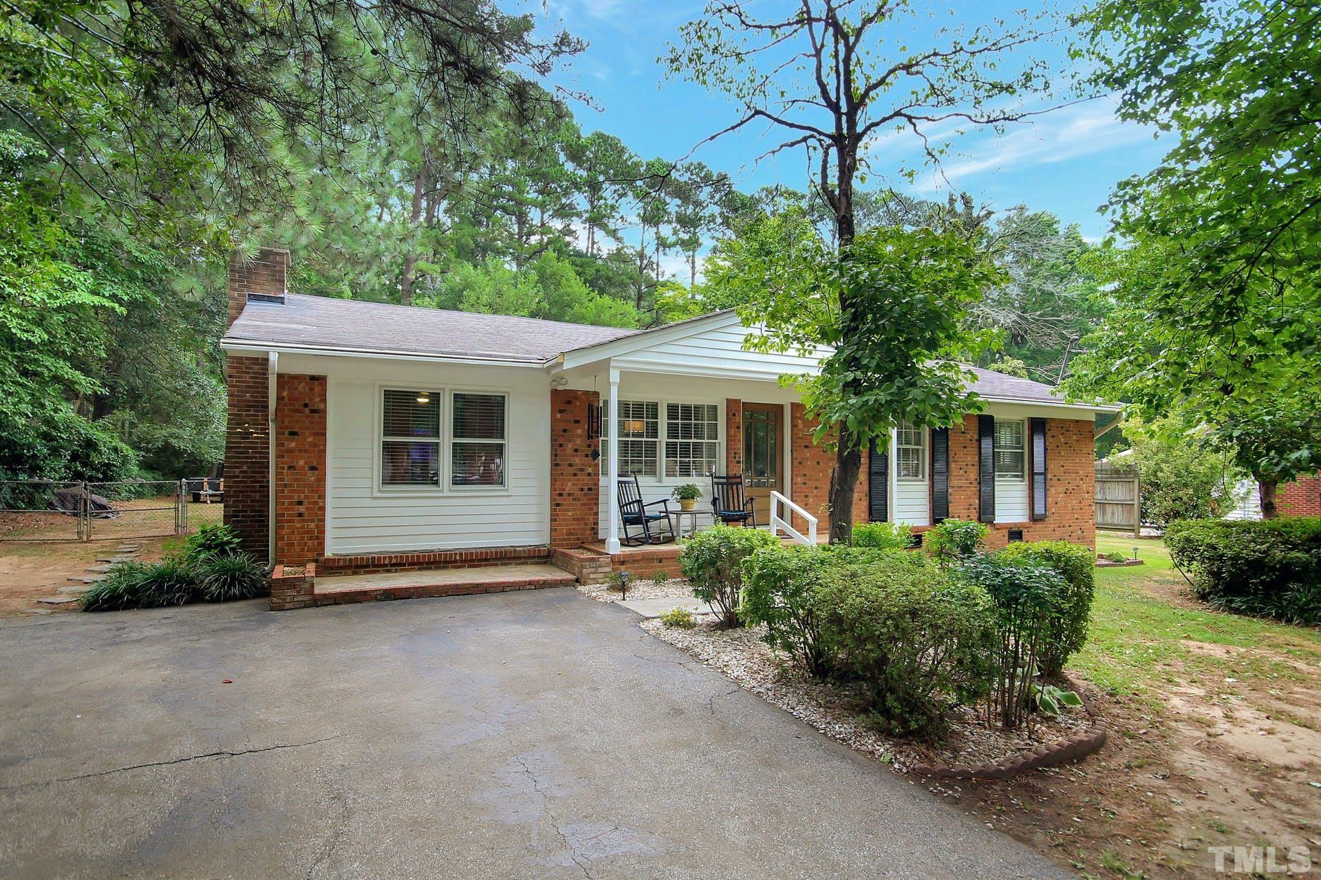 5913 Meadowbrook Road Raleigh, NC 27603 - Photo 2 of 24 a front view of a house with a garden
