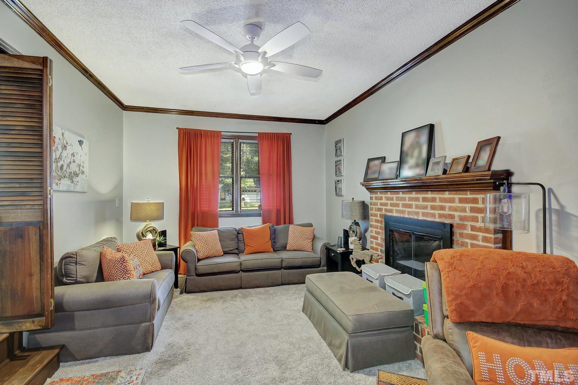 5913 Meadowbrook Road Raleigh, NC 27603 - Photo 5 of 24 a living room with furniture and a fireplace