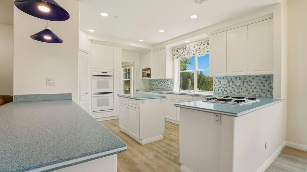 2527 Southern Oak Road Ramona, CA 92065 - Photo 21 of 56 a kitchen with white cabinets and appliances