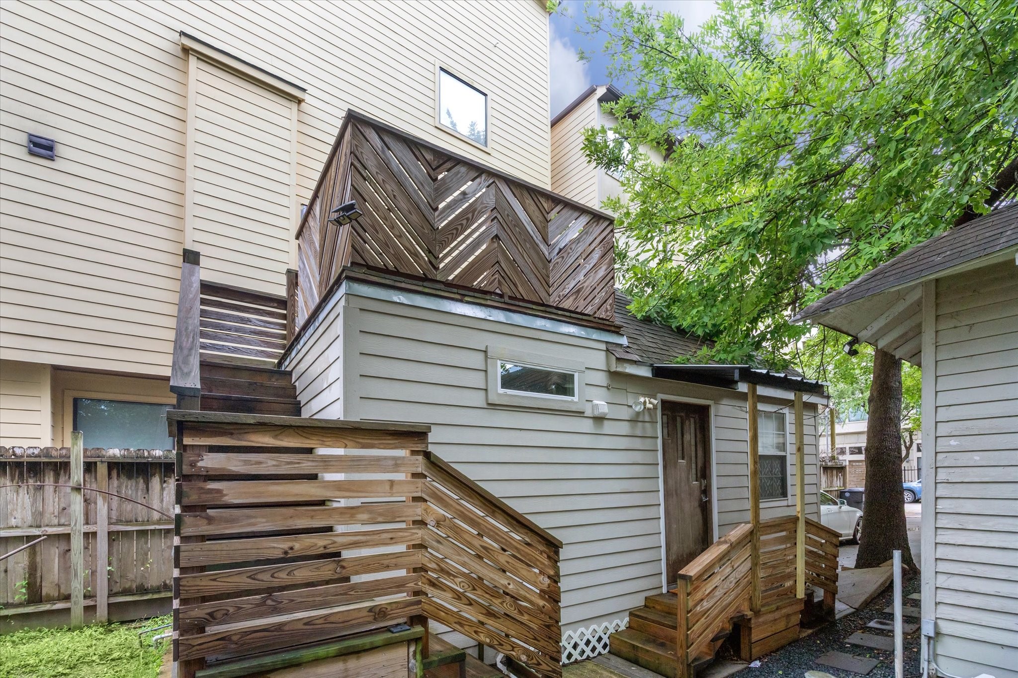 a view of a house with a door and wooden stairs
