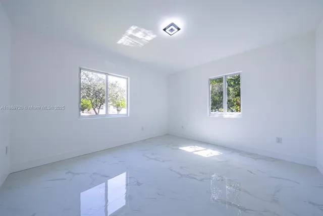 an empty room with windows and closet
