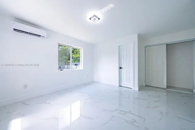 a view of an empty room with a window