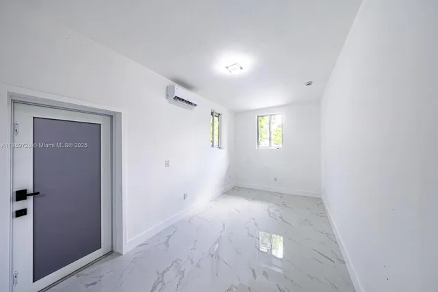 an empty room with windows and closet