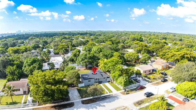 a view of a yard with flower plants and wooden fence