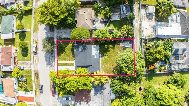 front view of a house with a lot of flower plants