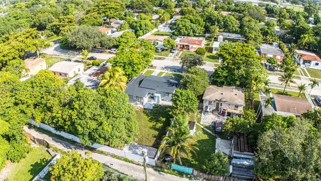 an aerial view of residential house with an outdoor space and seating