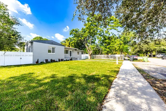 a front view of house with yard and green space