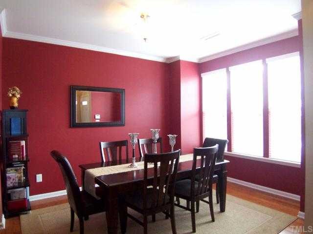 The lg sunny formal Dining Rm features a bump out w/triple-windows .