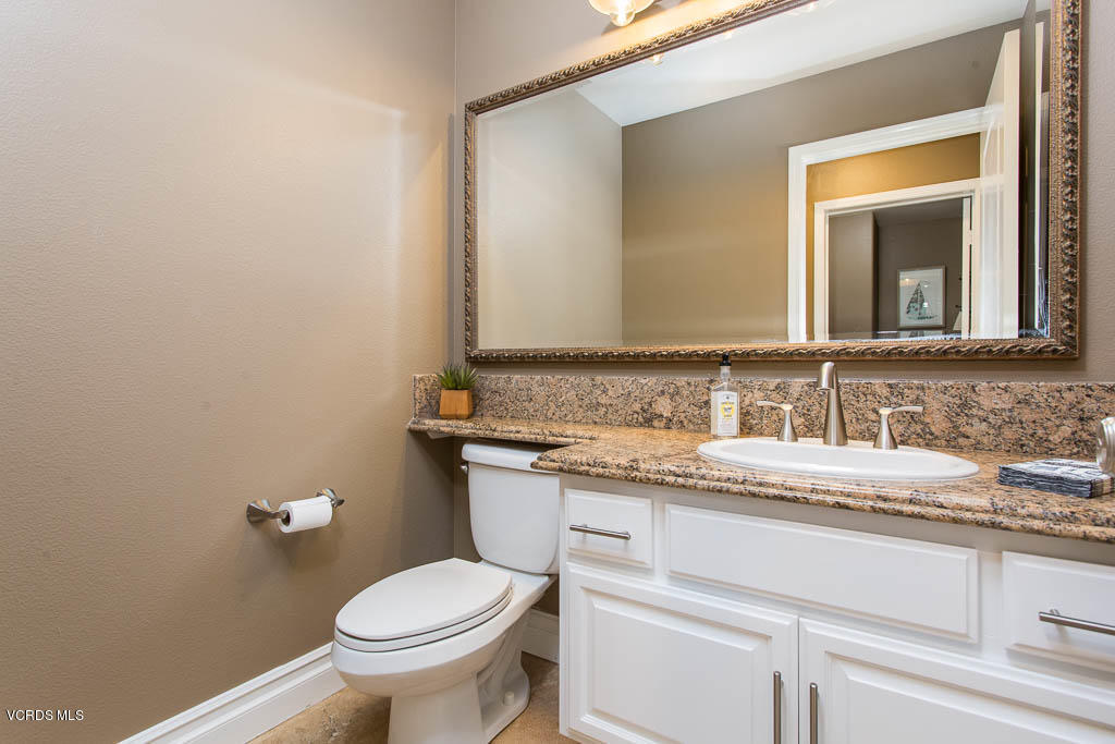 11245 Bentcreek Road Moorpark, CA 93021 - Photo 16 of 48 a bathroom with a granite countertop toilet sink and mirror