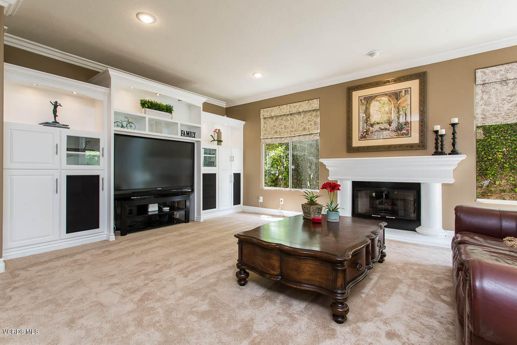 11245 Bentcreek Road Moorpark, CA 93021 - Photo 18 of 48 a living room with furniture a flat screen tv and a fireplace