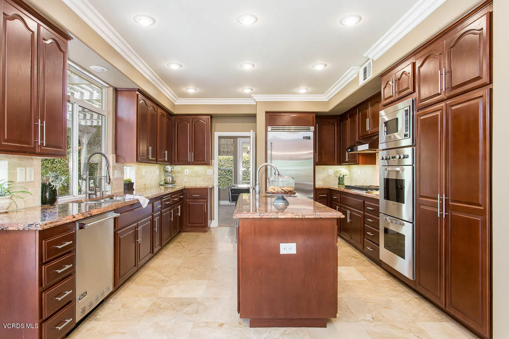 11245 Bentcreek Road Moorpark, CA 93021 - Photo 21 of 48 a large kitchen with stainless steel appliances granite countertop a stove refrigerator and a sink