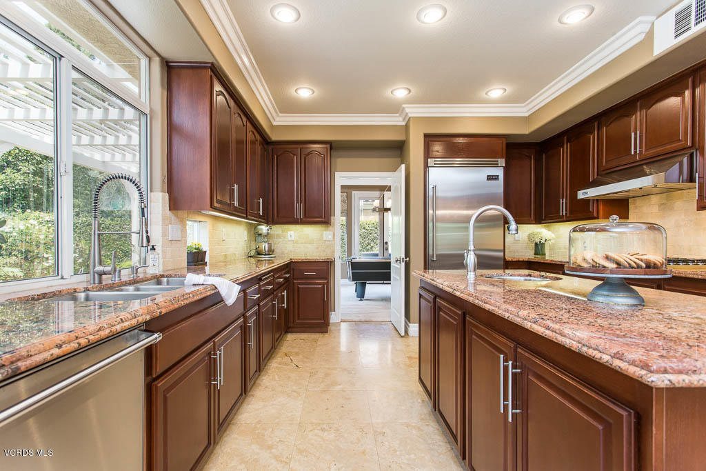 11245 Bentcreek Road Moorpark, CA 93021 - Photo 22 of 48 a kitchen with stainless steel appliances granite countertop a sink stove and cabinets
