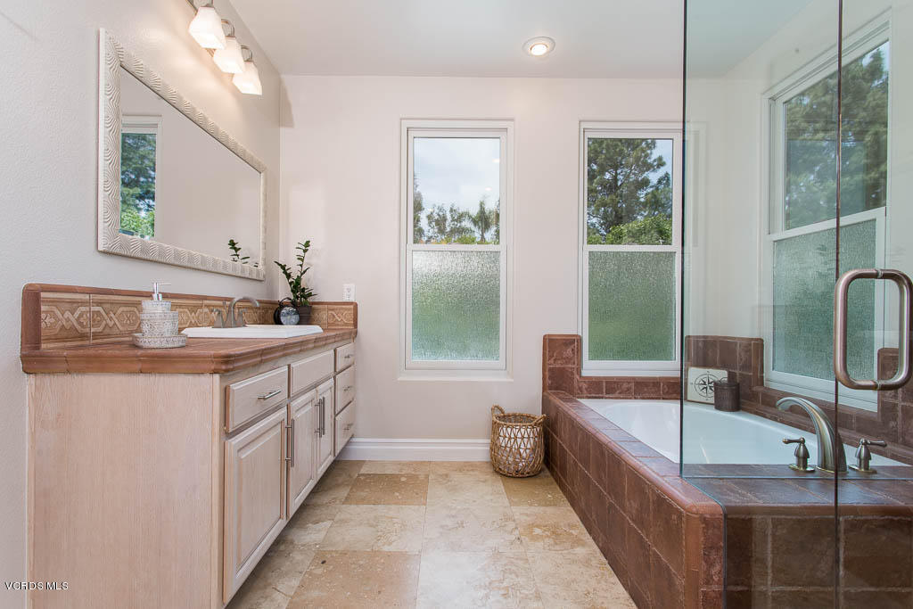 11245 Bentcreek Road Moorpark, CA 93021 - Photo 31 of 48 a bathroom with a tub sink and mirror