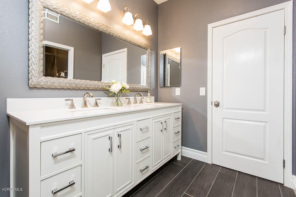 11245 Bentcreek Road Moorpark, CA 93021 - Photo 33 of 48 a spacious bathroom with a double vanity sink and a mirror